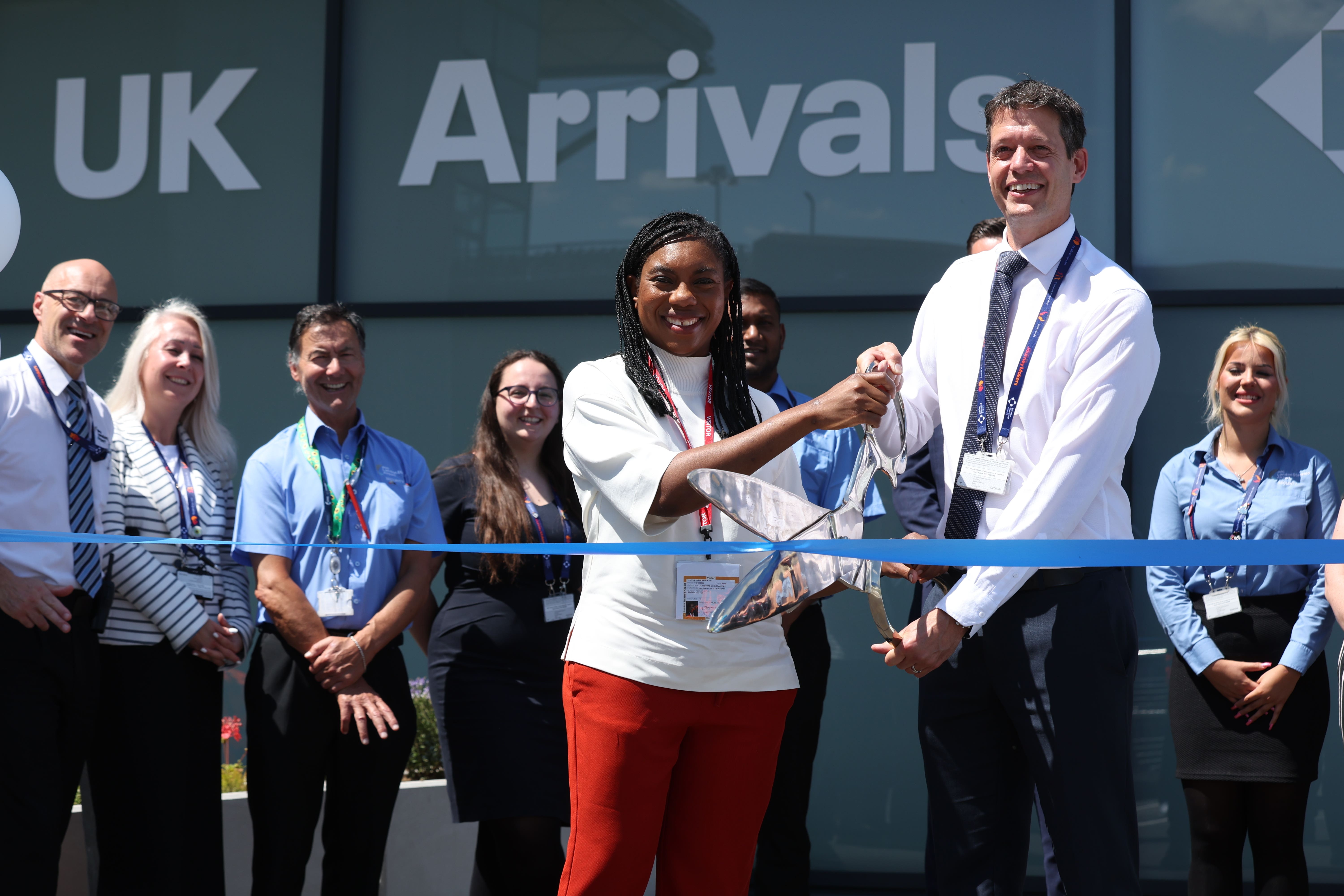 Conservative Party leader Kemi Badenoch cuts the ribbon at the opening of a new arrivals lounge at Stansted Airport in Essex (Chris Radburn/PA)