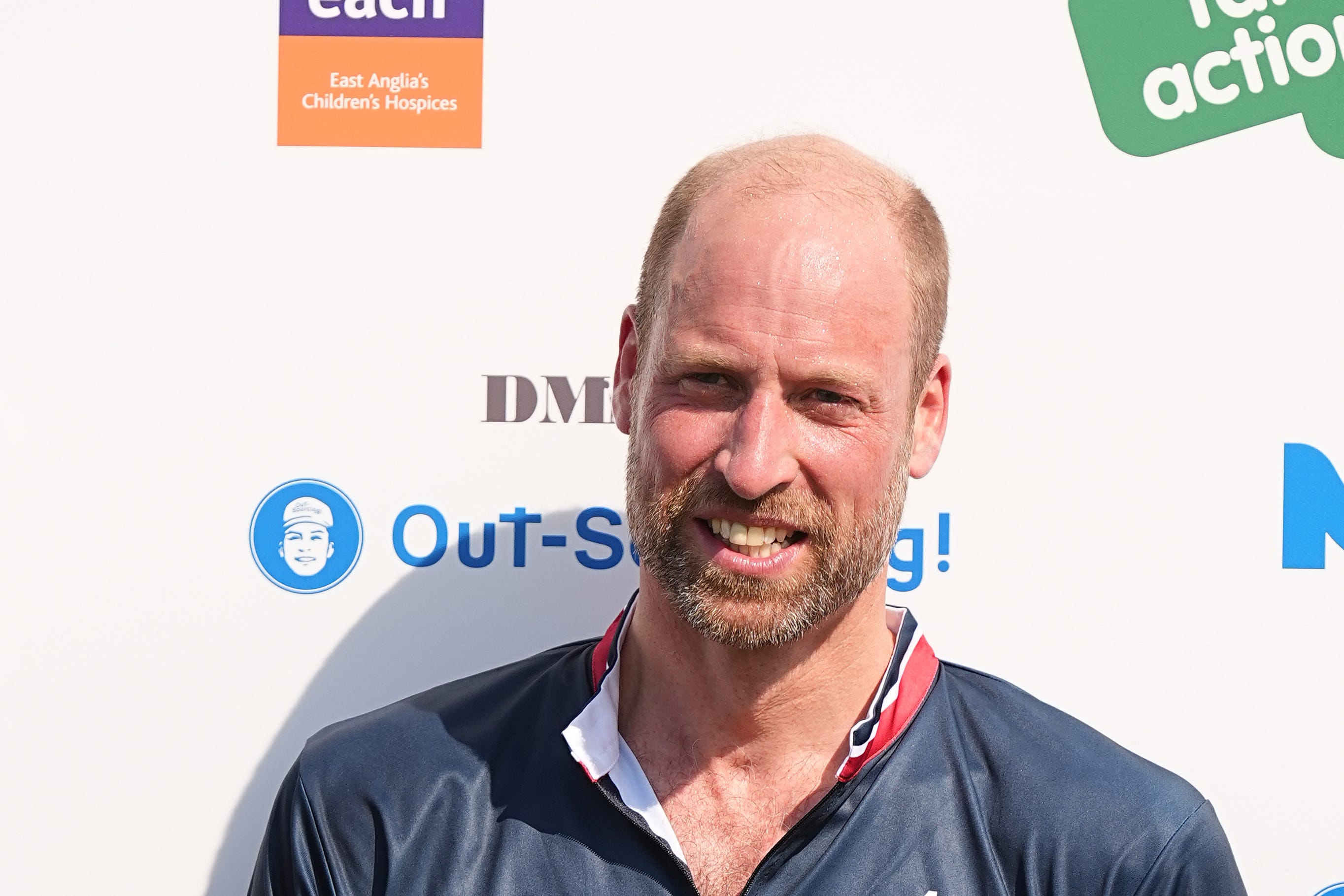 The Prince of Wales stands with the winning team (Aaron Chown/PA)