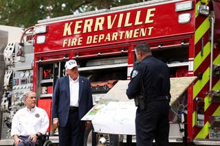 President Donald Trump and Texas Governor Greg Abbott receive a briefing from first responders as they visit the site of the July 4 flash flood.