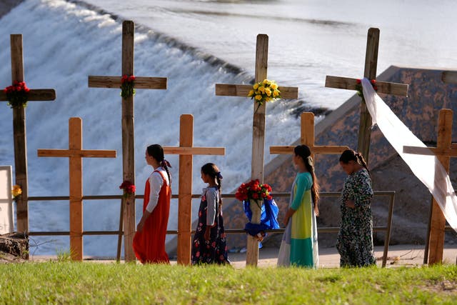 <p>Kerrville residents pay respects to at least 96 people killed in the county by the catastrophic flash floods on 4 July</p>
