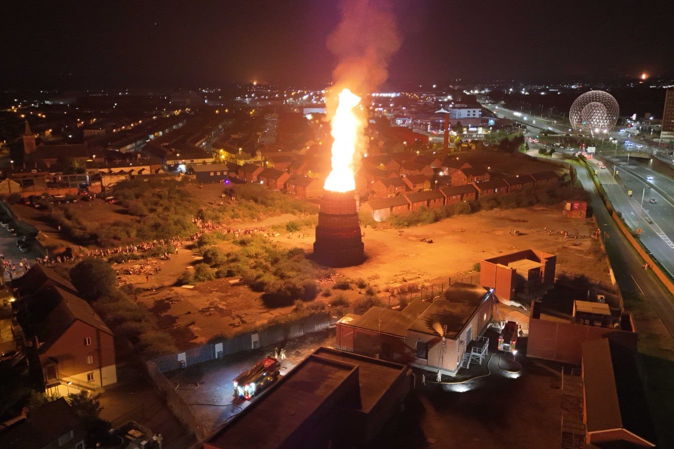A controversial loyalist bonfire off the Donegall Road in south Belfast is lit late on Friday night. (Niall Carson/PA)