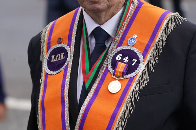 An Orange Order parade makes its way along the Crumlin Road towards the Ardoyne shops in Belfast (Brian Lawless/PA)