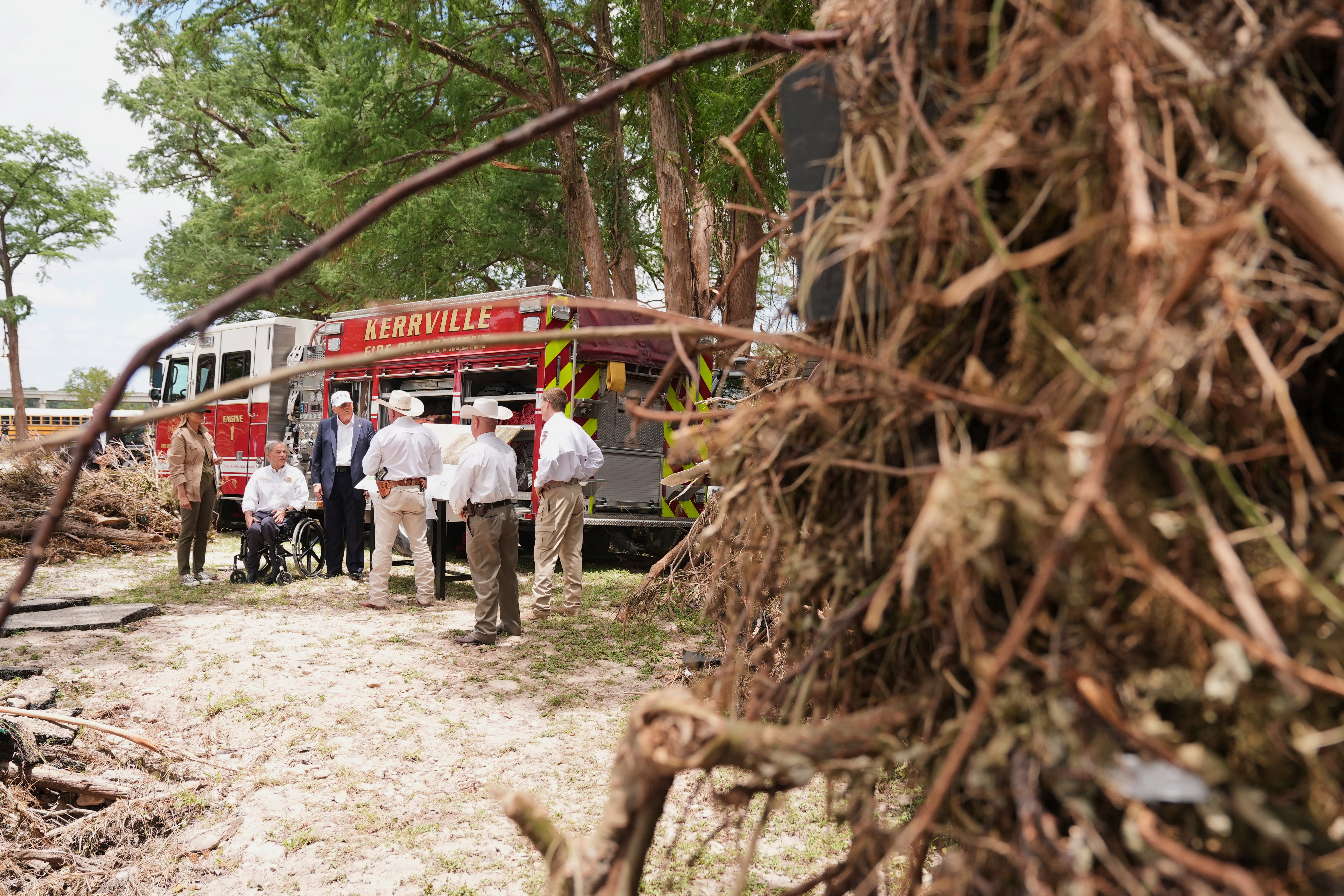 (From left) First lady Melania Trump, Texas Gov. Greg Abbott and US president Donald Trump are briefed on flood damage in Kerrville, Texas, on Friday