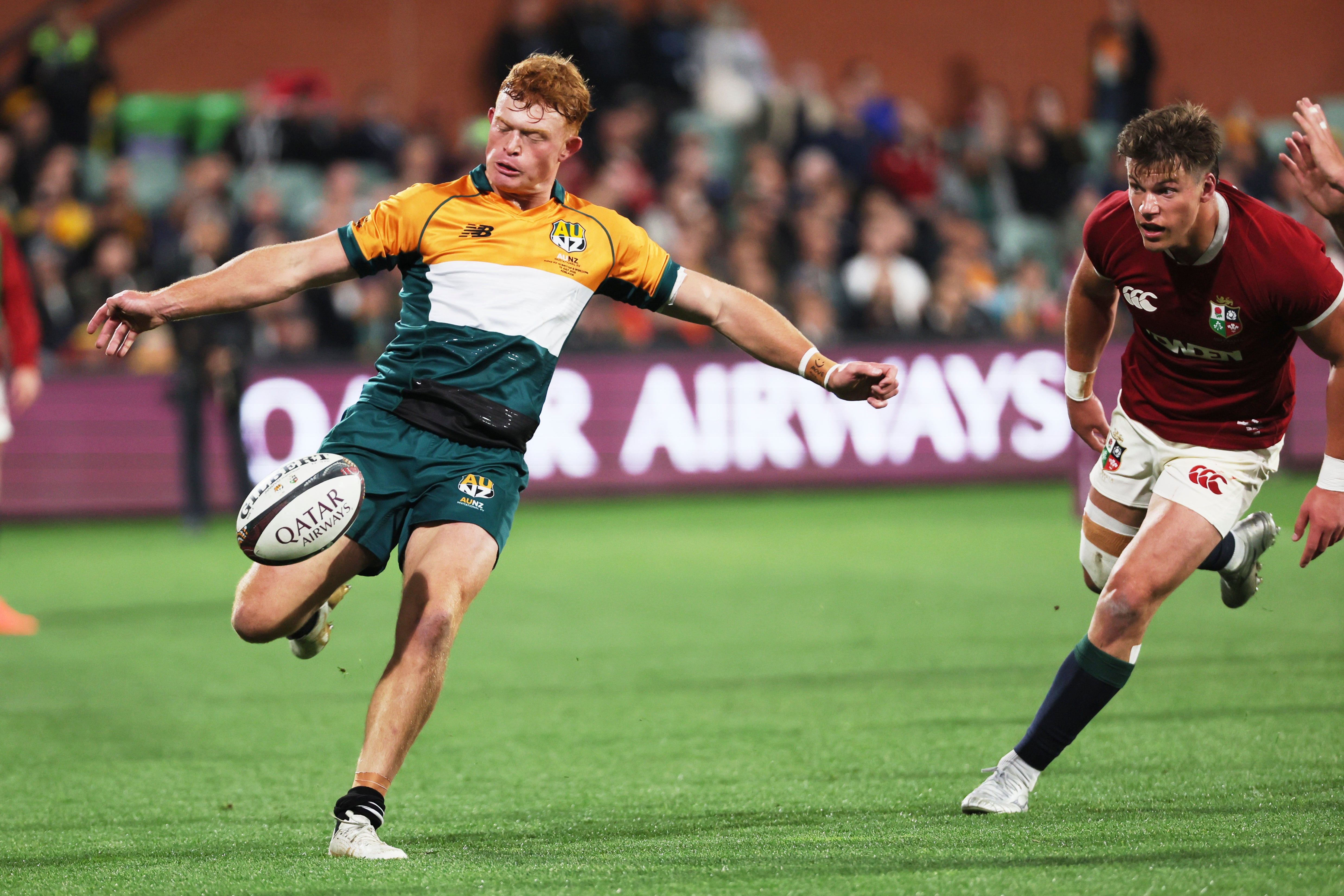 Tane Edmed of the AUNZ Invitational XV kicks the ball