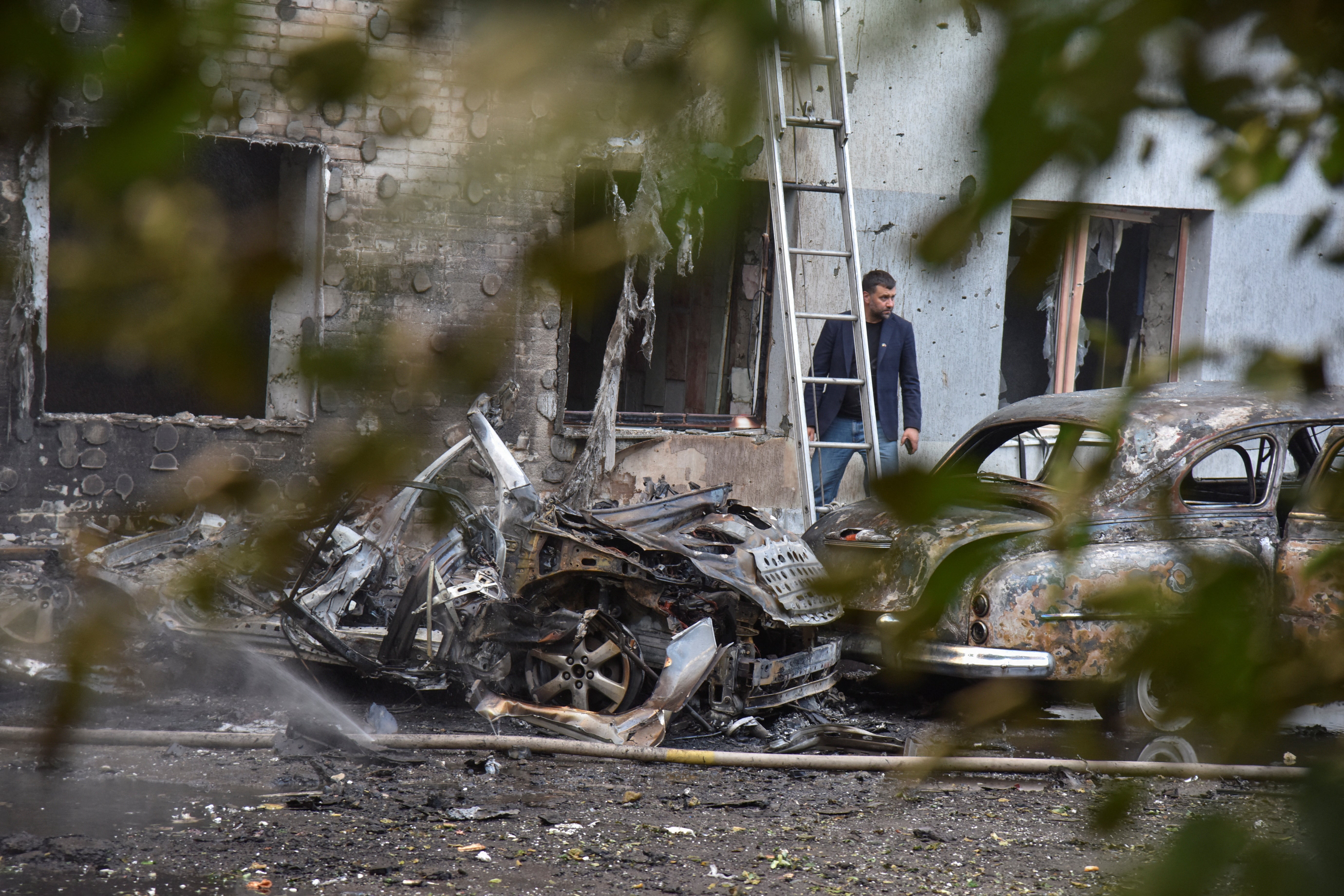 A resident is seen at the site of buildings damaged during Russian drone and missile strikes in Lviv