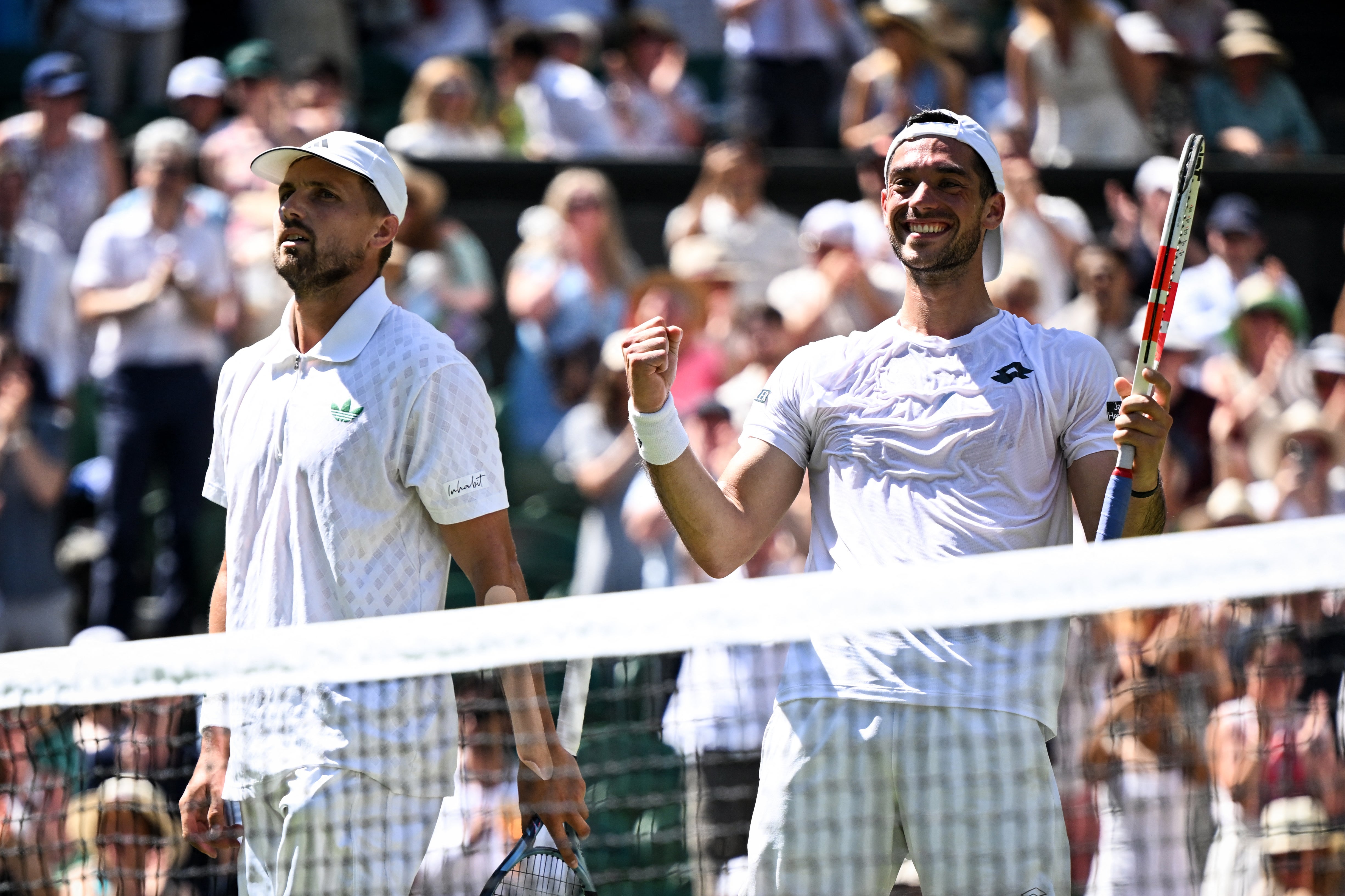 Britain's Lloyd Glasspool and Julian Cash celebrate after winning against Australia's Rinky Hijikata playing with Netherlands' David Pel