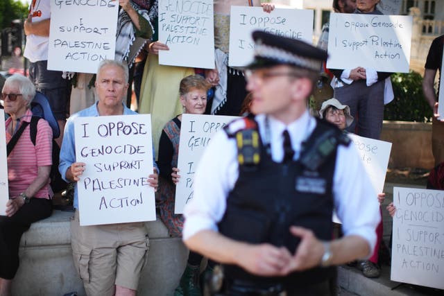 People take part in a protest in Parliament Square, London, to call for de-proscription of Palestine Action (James Manning/PA)