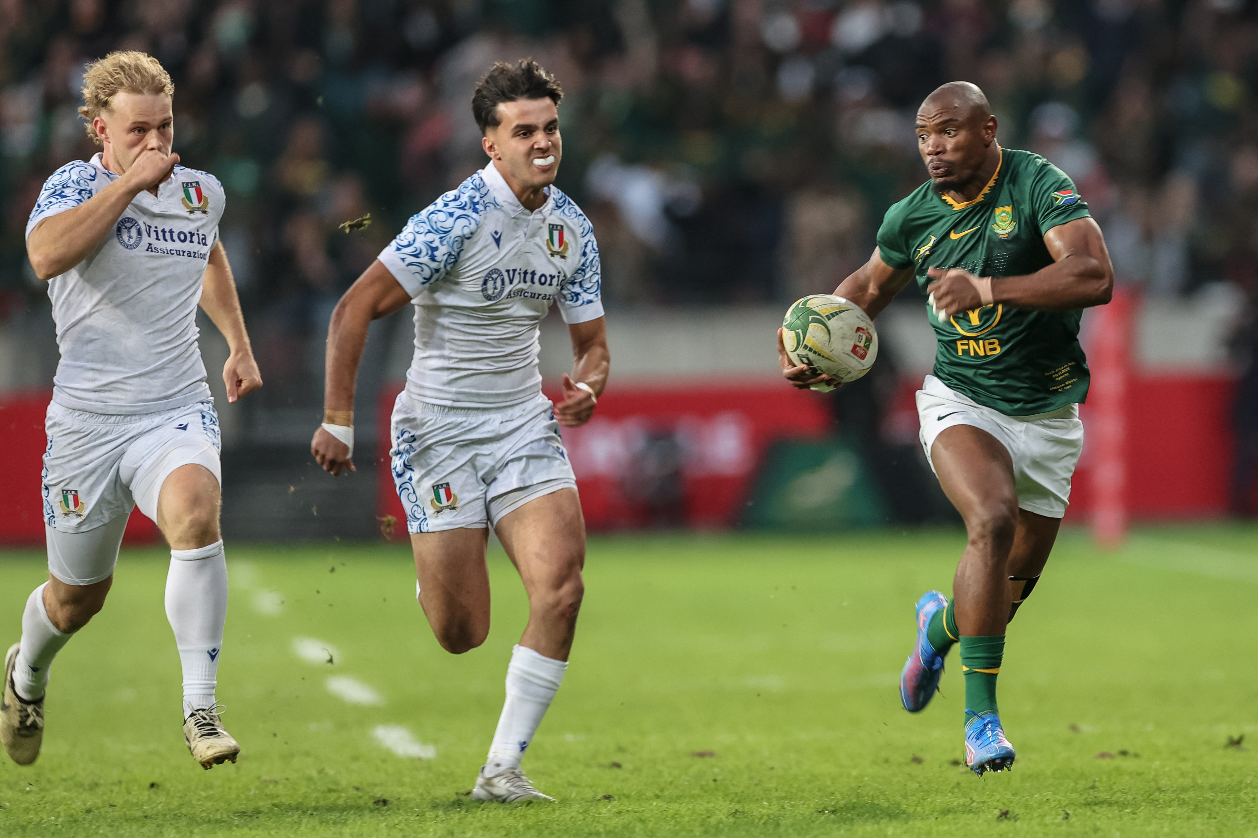 South Africa's wing Makazole Mapimpi (R) runs with the ball during the international rugby union Test match between South Africa and Italy