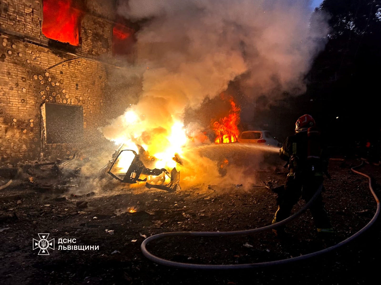 A firefighter works at the site of a Russian drone strike, amid Russia's attack on Ukraine, in Lviv