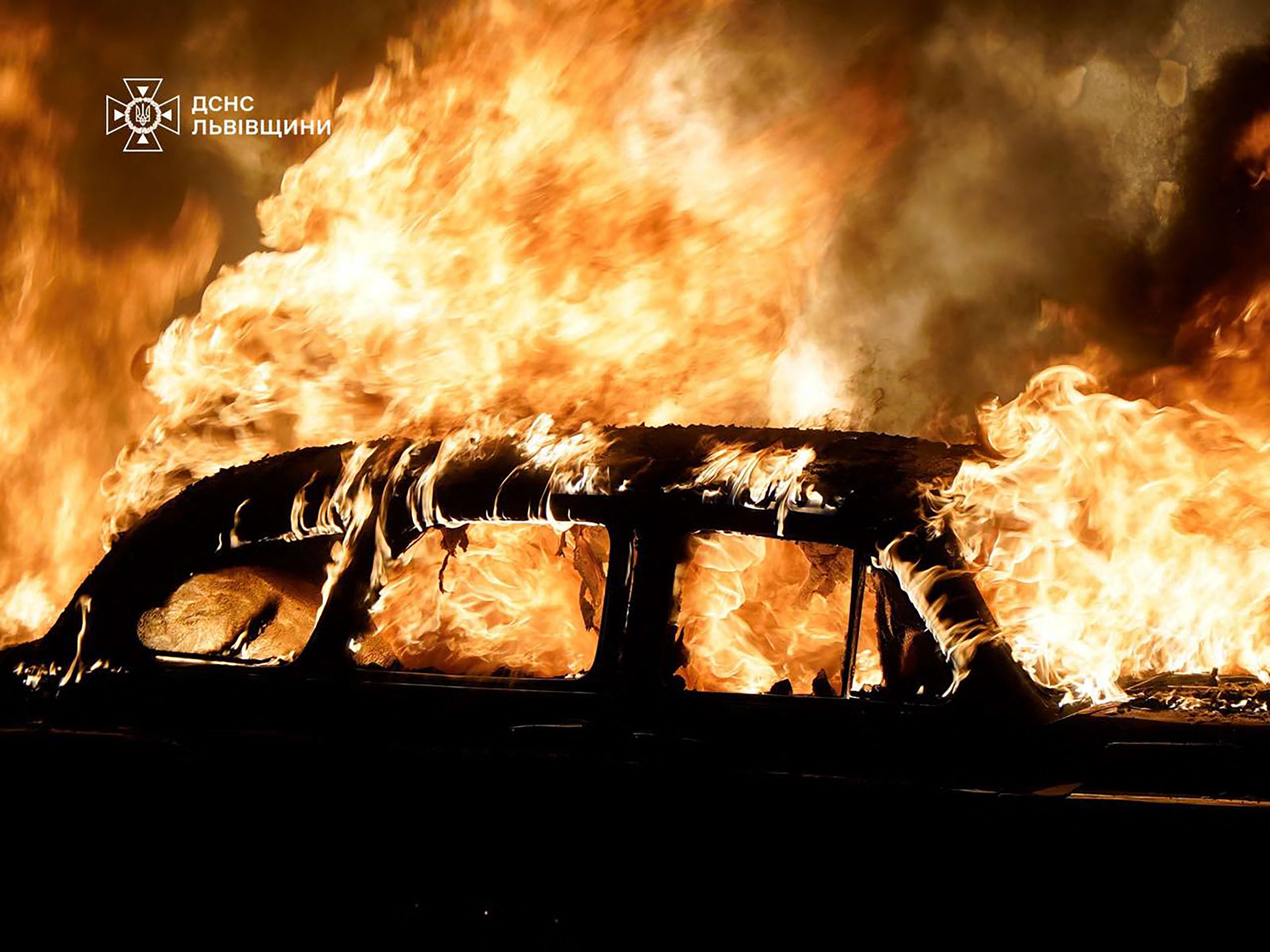 A car burning following mass Russian strikes in the western Ukrainian city of Lviv