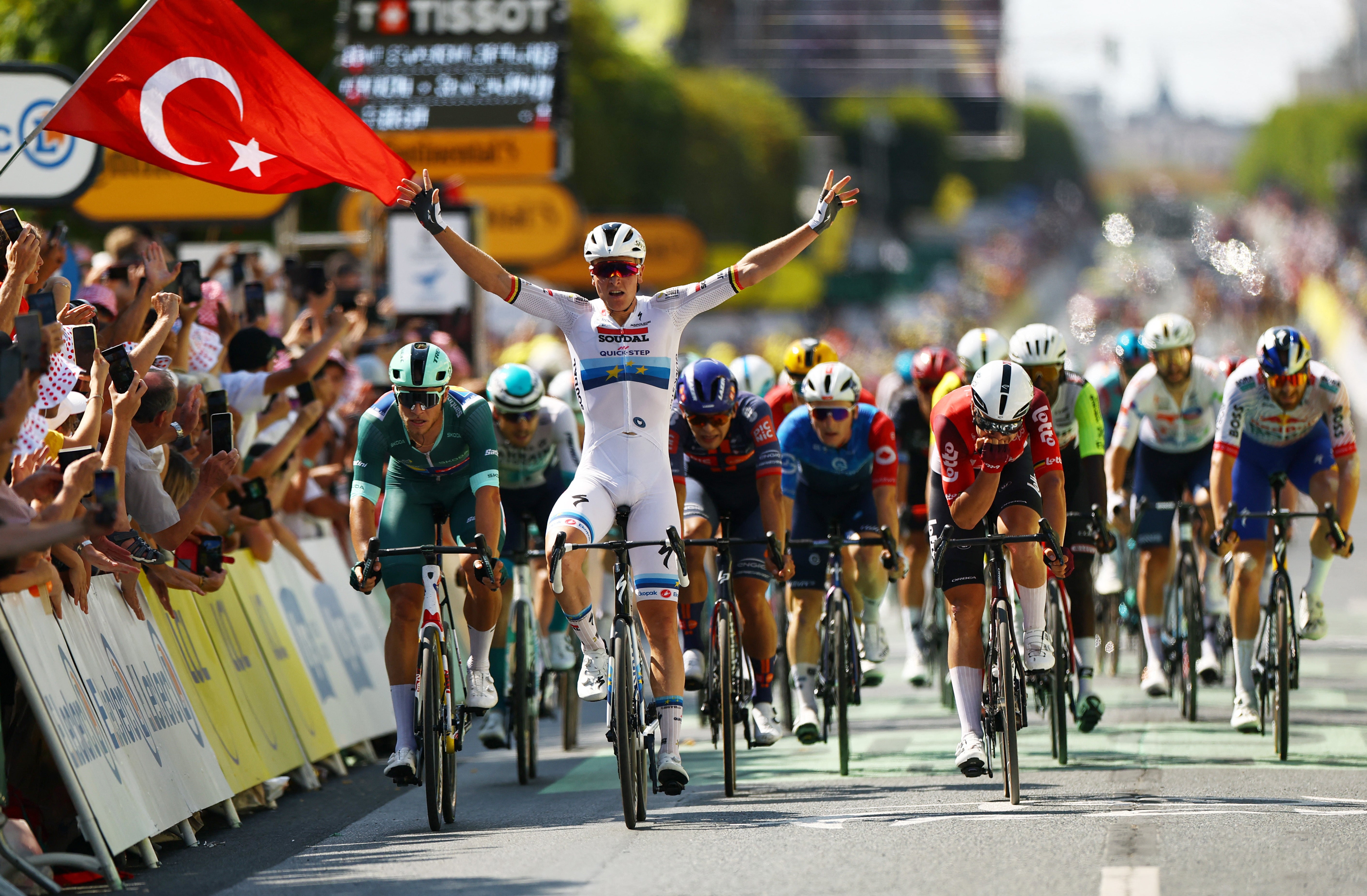 Tim Merlier celebrates after claiming victory in Chateautoux