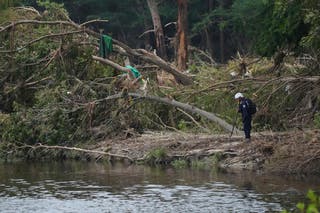 Search and rescue crews review the river Guadalupa in the sail of the deadly floods on independence day