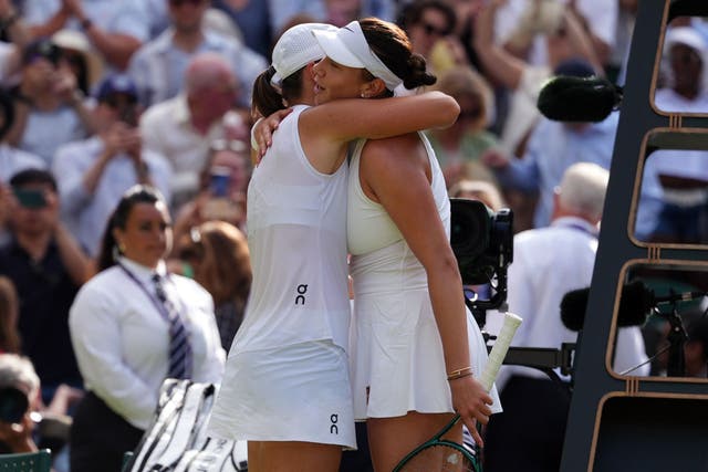 Iga Swiatek consoles Amanda Anisimova on Centre Court (John Walton/PA)
