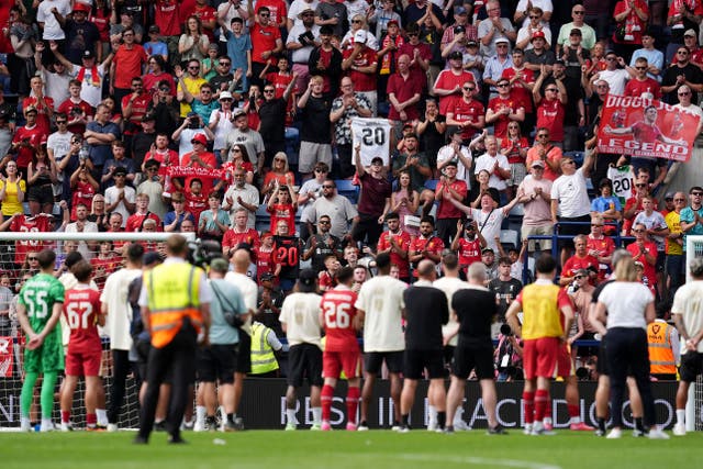 <p>Liverpool fans pay tribute to Diogo Jota as the players watch on following the pre-season friendly at Preston</p>