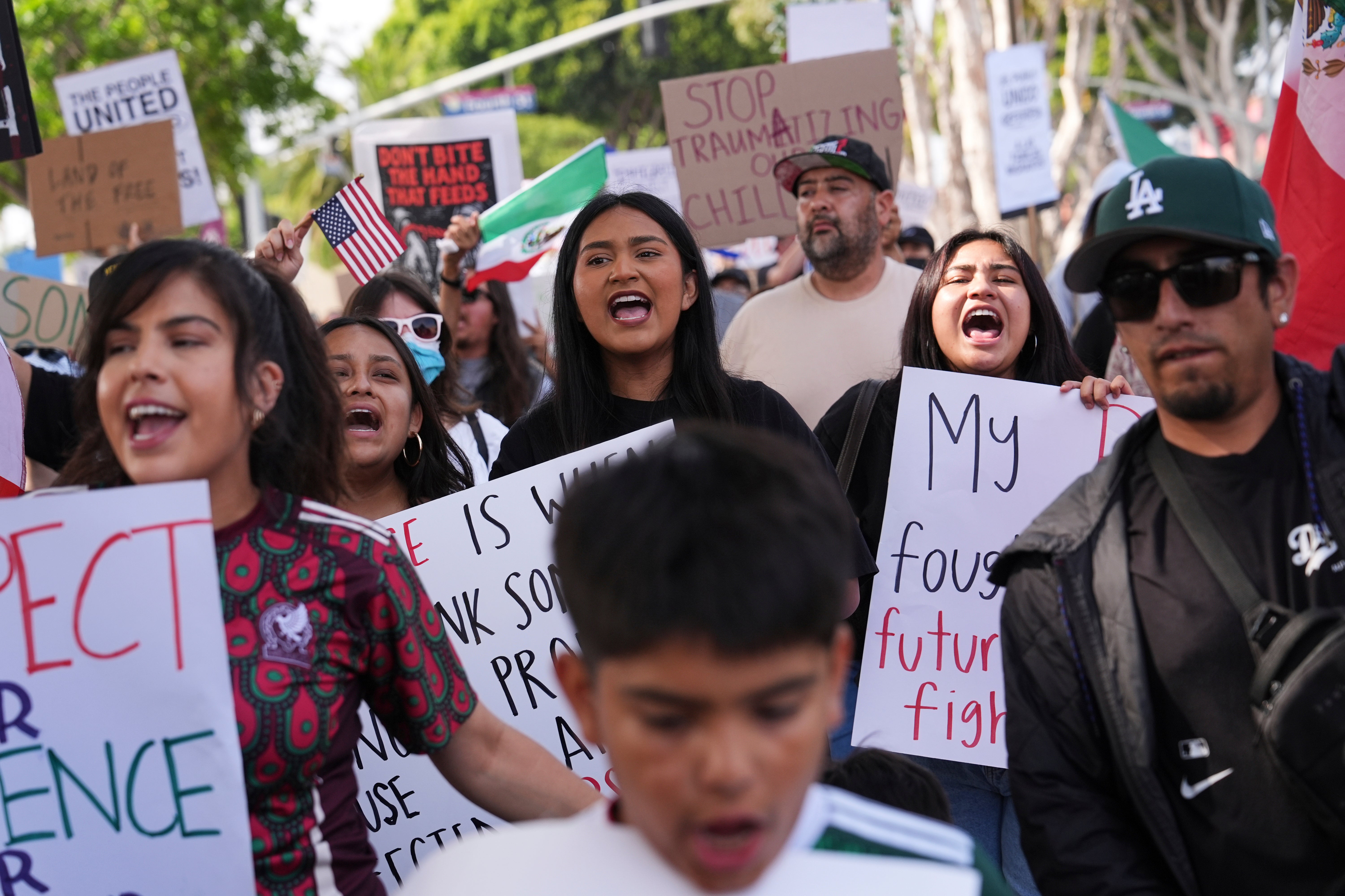 Demonstrators march during a protest in reaction to recent immigration raids in Oxnard, Calif