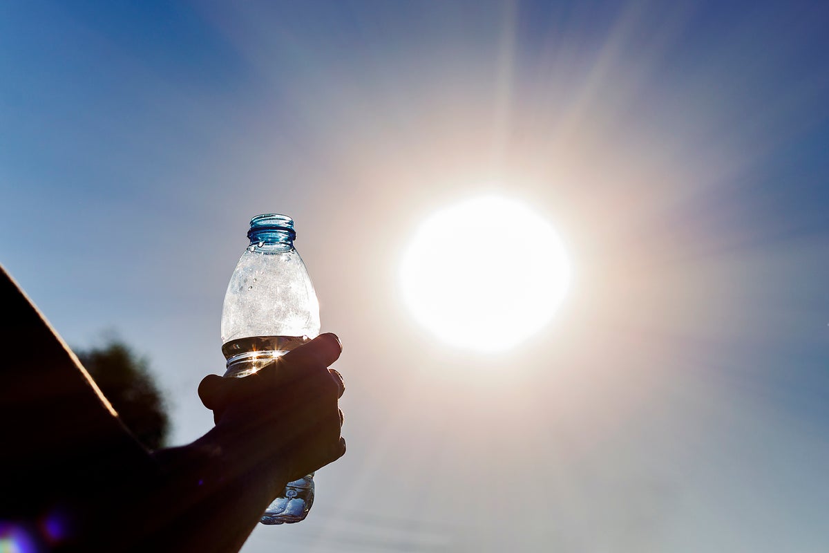https://static.independent.co.uk/2025/07/14/14/06/A-woman-holds-a-bottle-of-water-with-a-sunny-sky-in-the-background.jpeg?width=1200&height=800&crop=1200:800