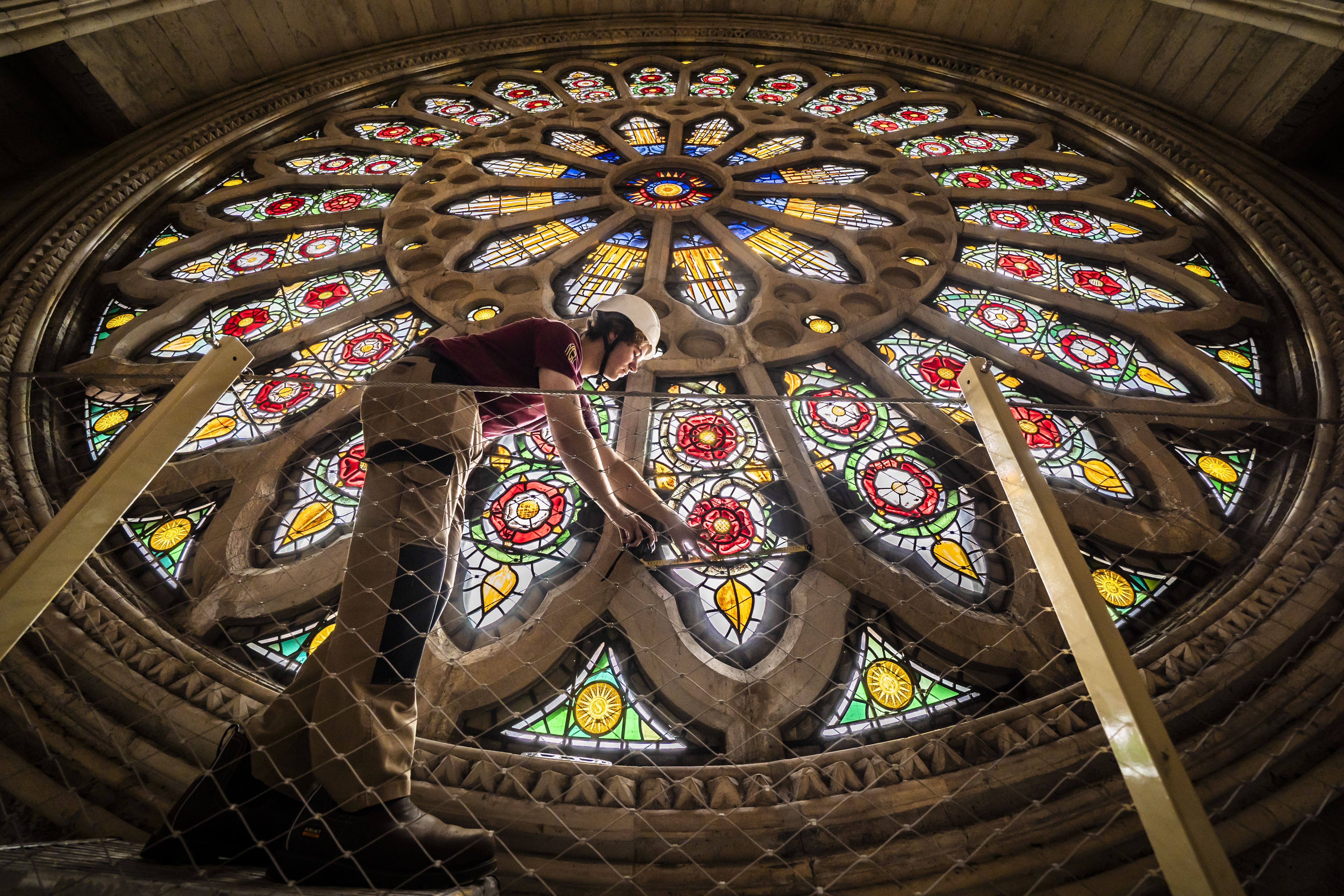 Theo Dives, apprentice glazier at York Glaziers Trust, begins an analysis of York Minster’s Rose Window, part of a significant restoration project (Danny Lawson/PA)