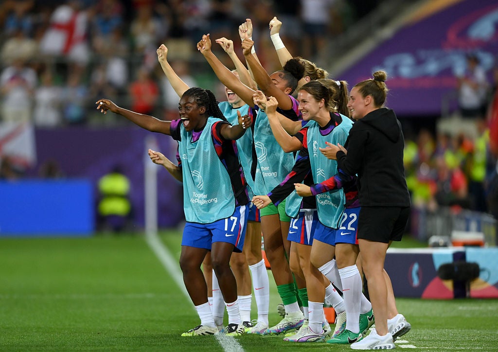 The England players on the bench celebrate Beth Mead's goal against Wales