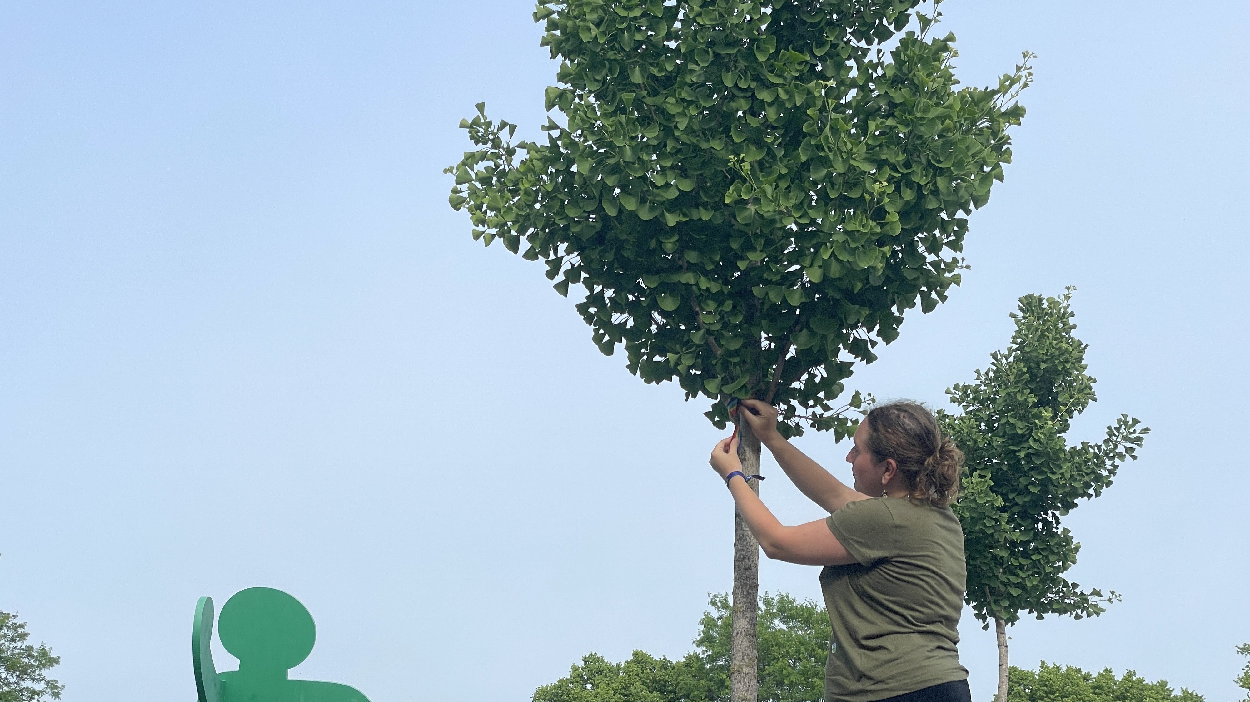 Rory ties a rainbow ribbon at Chicago's Aids Garden
