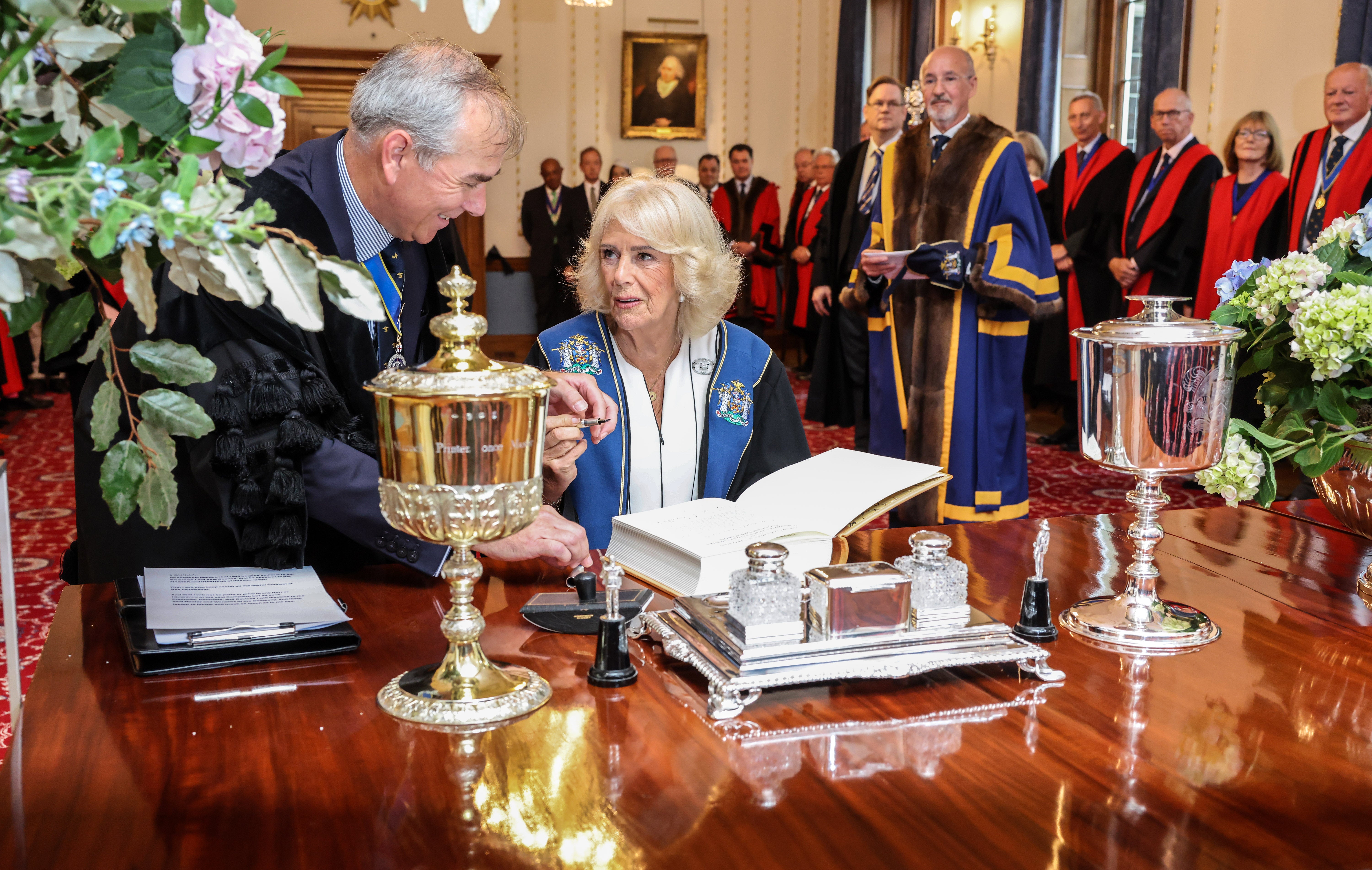 Queen Camilla' signs the book after after being installed as an Honorary Freeman and Liveryman of the Worshipful Company of Stationers and Newspaper Makers, at Stationers' Hall, London, in recognition of her service to literacy