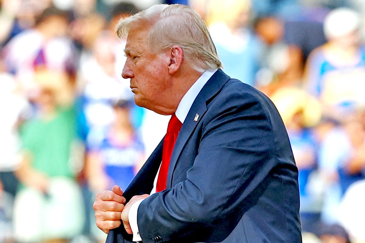 Trump seen pocketing FIFA medal as he walks on stage to hand Chelsea replica club championship trophy