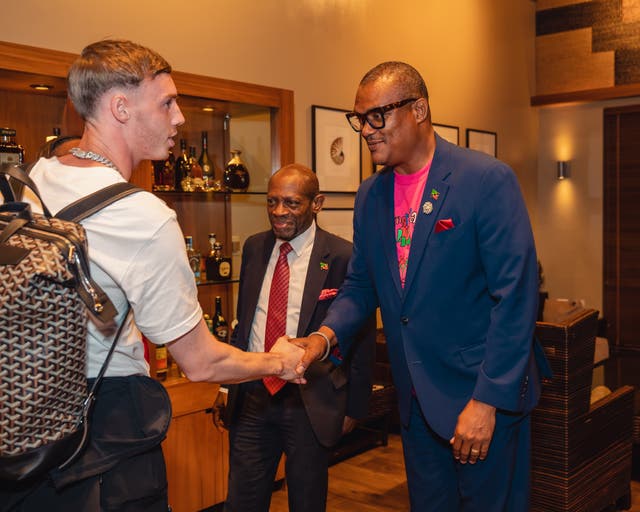 <p>Cole Palmer met the deputy prime minister of St Kitts and Nevis, Geoffrey Hanley, as he arrived on the island (Daryl Grant/St Kitts Toursim Authority/PA)</p>