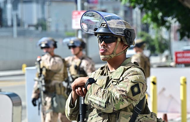 Members of the California National Guard stand watch in front of the Edward Roybal Federal Building on the morning of June 17, 2025 in Los Angeles, California. A California court will hear arguments Tuesday on whether US President Donald Trump must give up control of the state's National Guard after he sent troops to protest-hit Los Angeles against the wishes of local officials. Trump has deployed more than 4,000 guardsmen -- as well as 700 Marines -- to the second-largest US city, where his immigration crackdown has sparked fierce, mostly peaceful opposition with some violence and vandalism. (Photo by Frederic J. BROWN / AFP) (Photo by FREDERIC J. BROWN/AFP via Getty Images)
