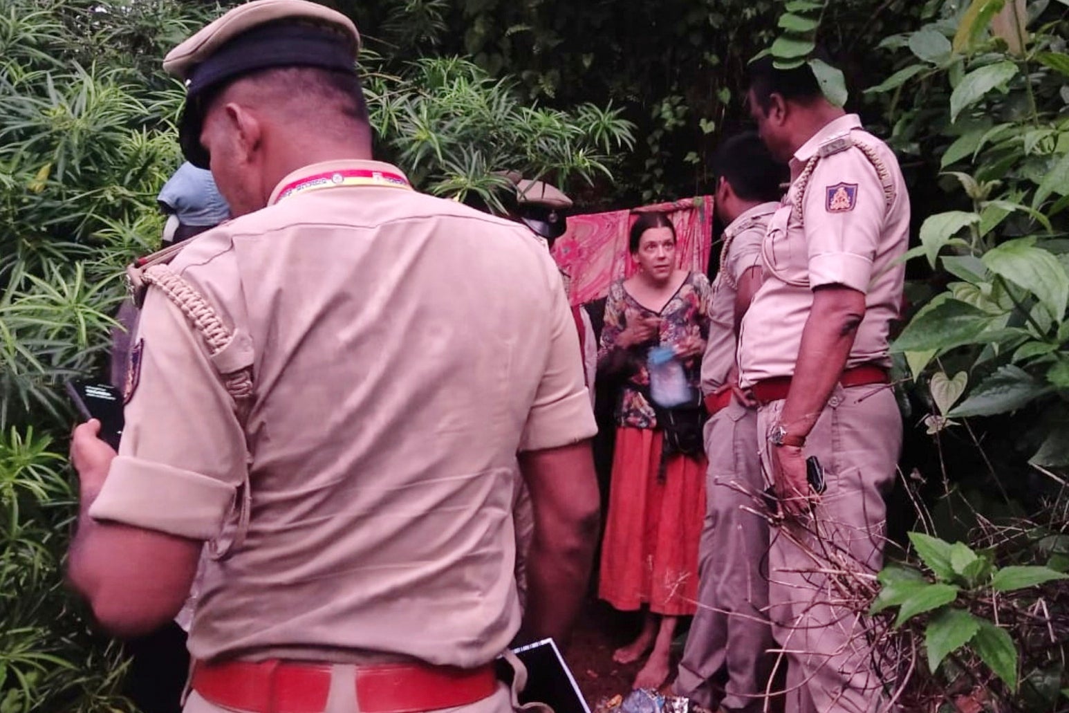 Indian policemen rescue Nina Kutina, 40, a Russian woman, from a cave in forest area of Ramtirtha hills in southern Indian state of Karnataka