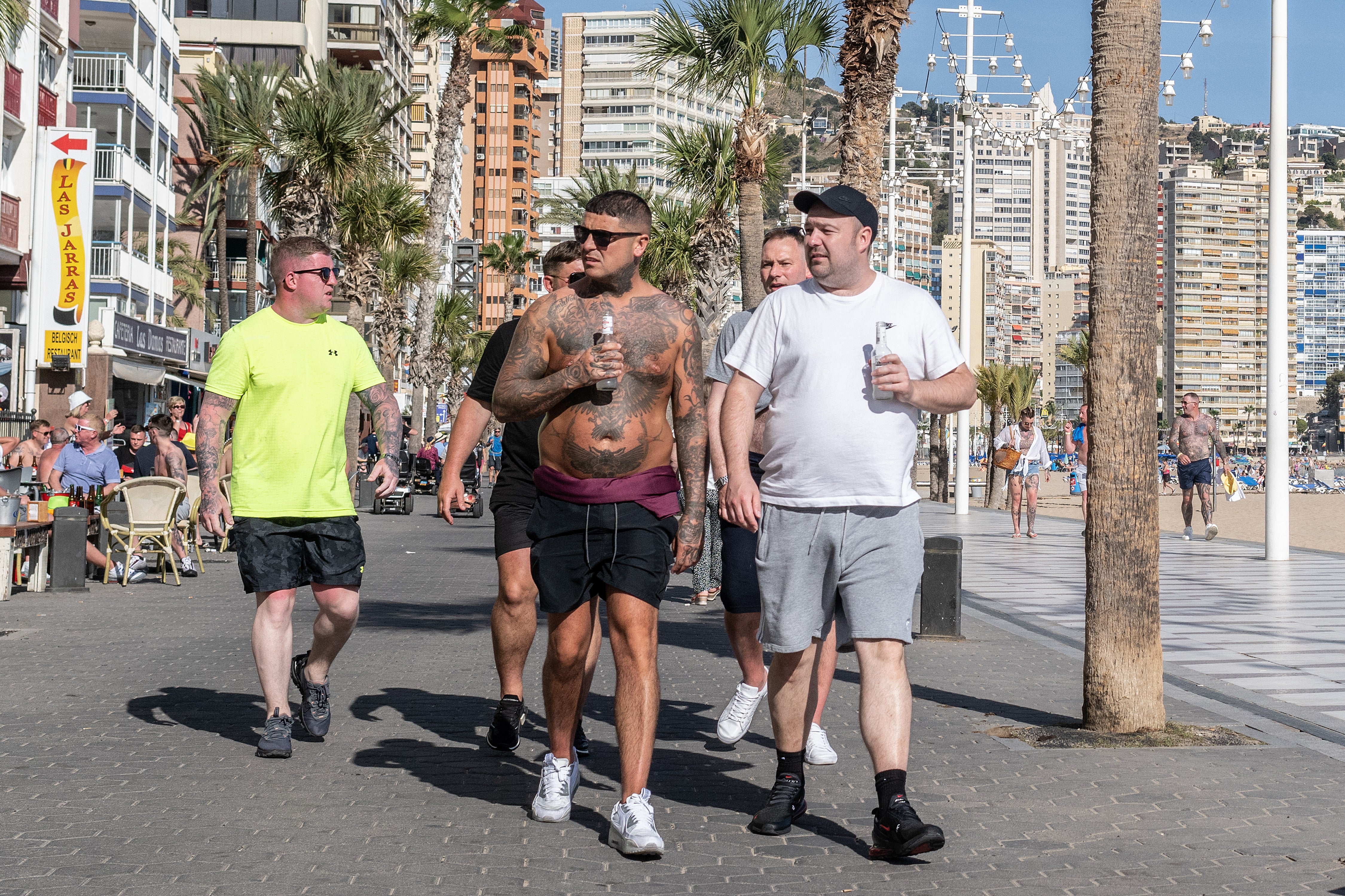 British tourists walk along Levante promenade in Benidorm, Spain, in 2023