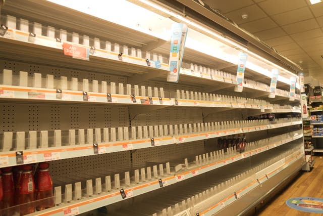 <p>Empty shelves in a branch of the Co-op following a cyber attack</p>
