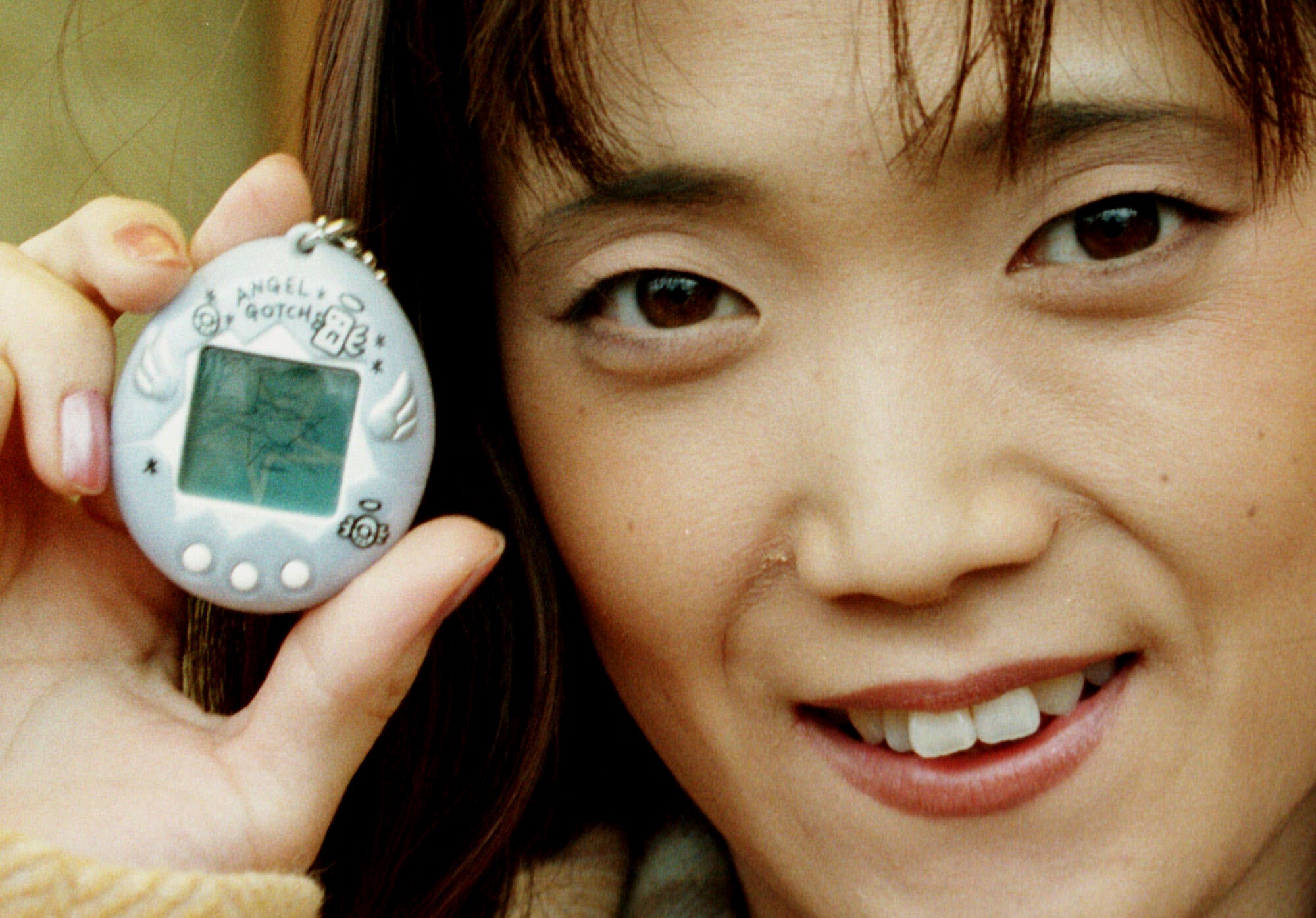 Aki Maita, Japanese developer of the Tamagotchi digital pet, shows on Monday, December 15, 1997