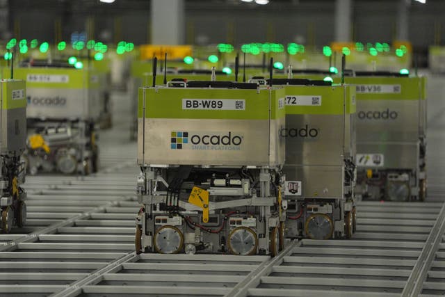 Automated picking machines at the Ocado distribution warehouse in Luton. The company saw shares jump after reporting a return to profit and stronger sales (Jonathan Brady/PA)
