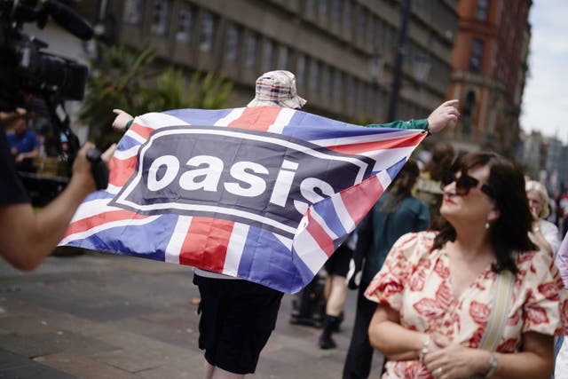 <p>An Oasis fan in Cardiff ahead of the first show in the band’s long-awaited reunion tour earlier this month</p>