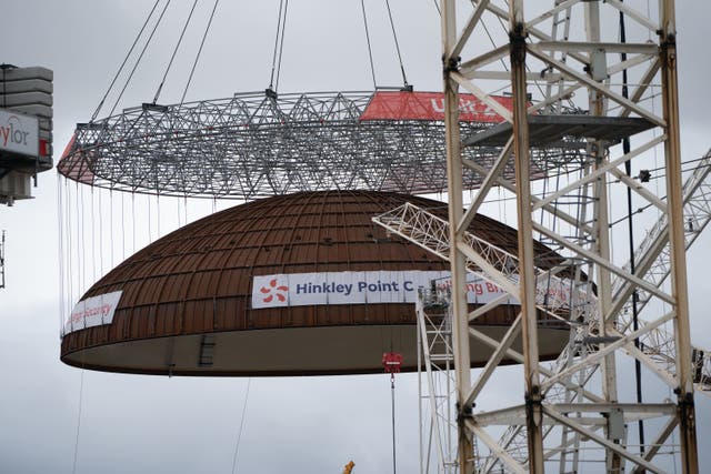 Engineering teams use the world’s largest crane – Big Carl – to lift a 245-tonne steel dome onto Hinkley Point C’s second reactor building, at the nuclear power station construction site in Bridgwater, Somerset. The dome closes the building allowing the installation of the nuclear reactor and equipment. Picture date: Thursday July 17, 2025.