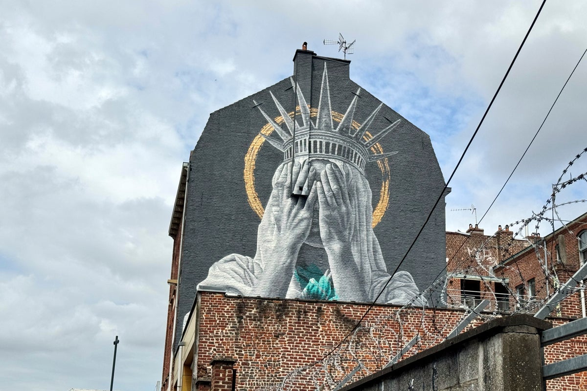 A new mural in France shows the Statue of Liberty covering her eyes in a swipe at Trump