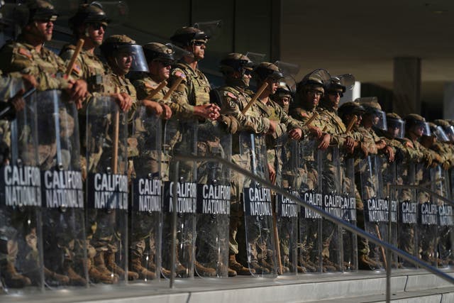 <p>California National Guard troops stand guard as protests swelled in Los Angeles last month. Trump deployed more than 4,000 troops to the area</p>