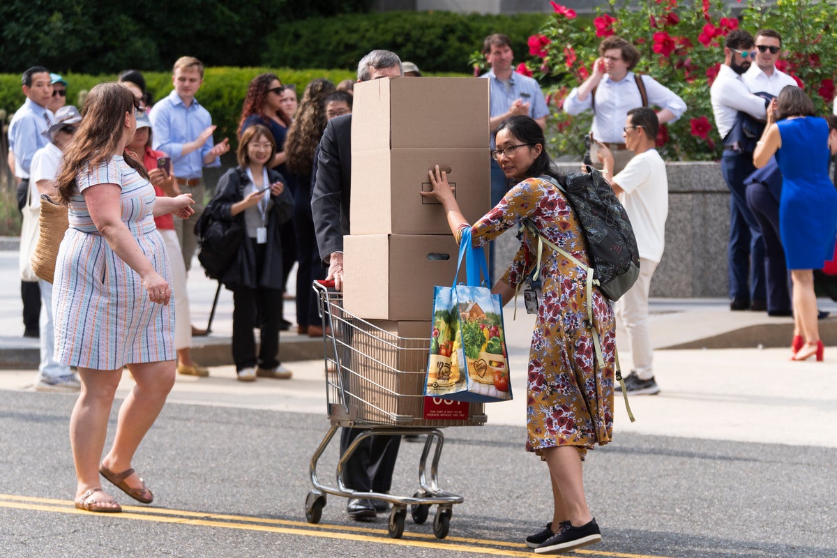 Photos of US State Department workers getting hugs and applause as they're fired