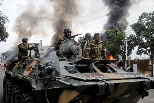 <p>Soldiers sit atop an APC after armed forces were deployed, following a clash during a National Citizen Party rally</p>