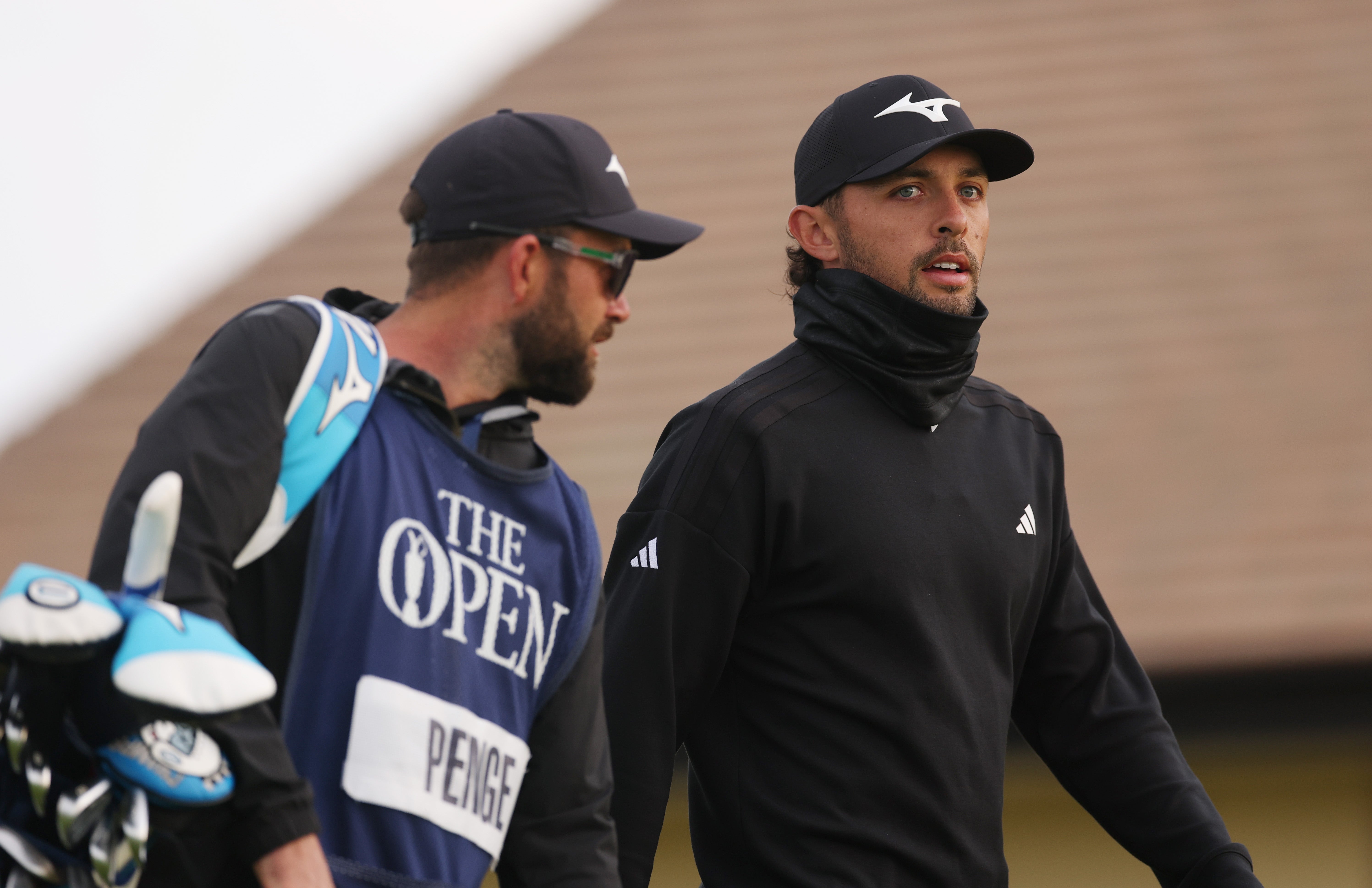 Marco Penge of England and his caddie walk on the first hole