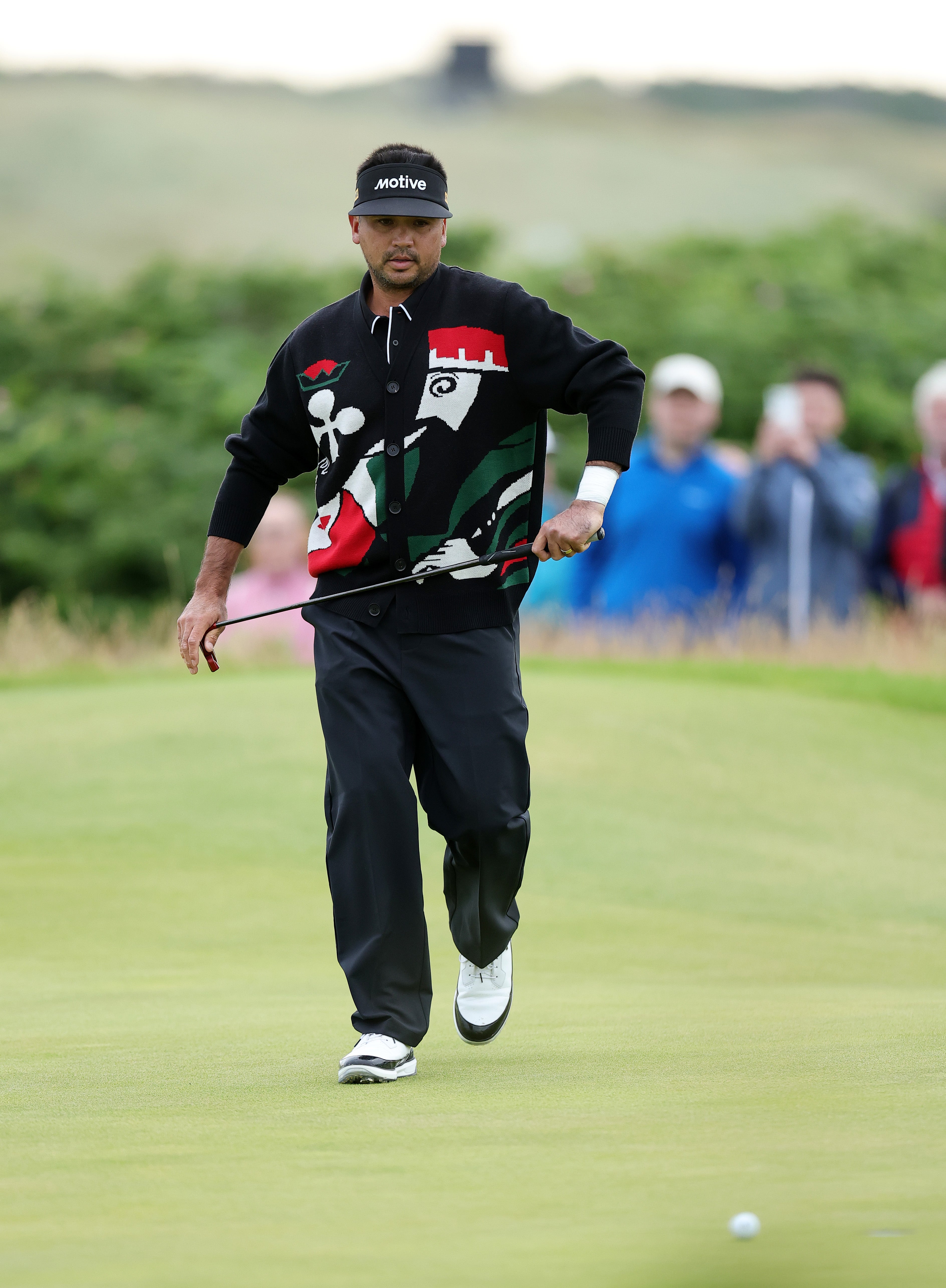 Jason Day of Australia putts on the first green