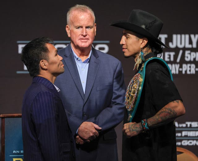 <p>Manny Pacquiao (left) and Mario Barrios face off</p>