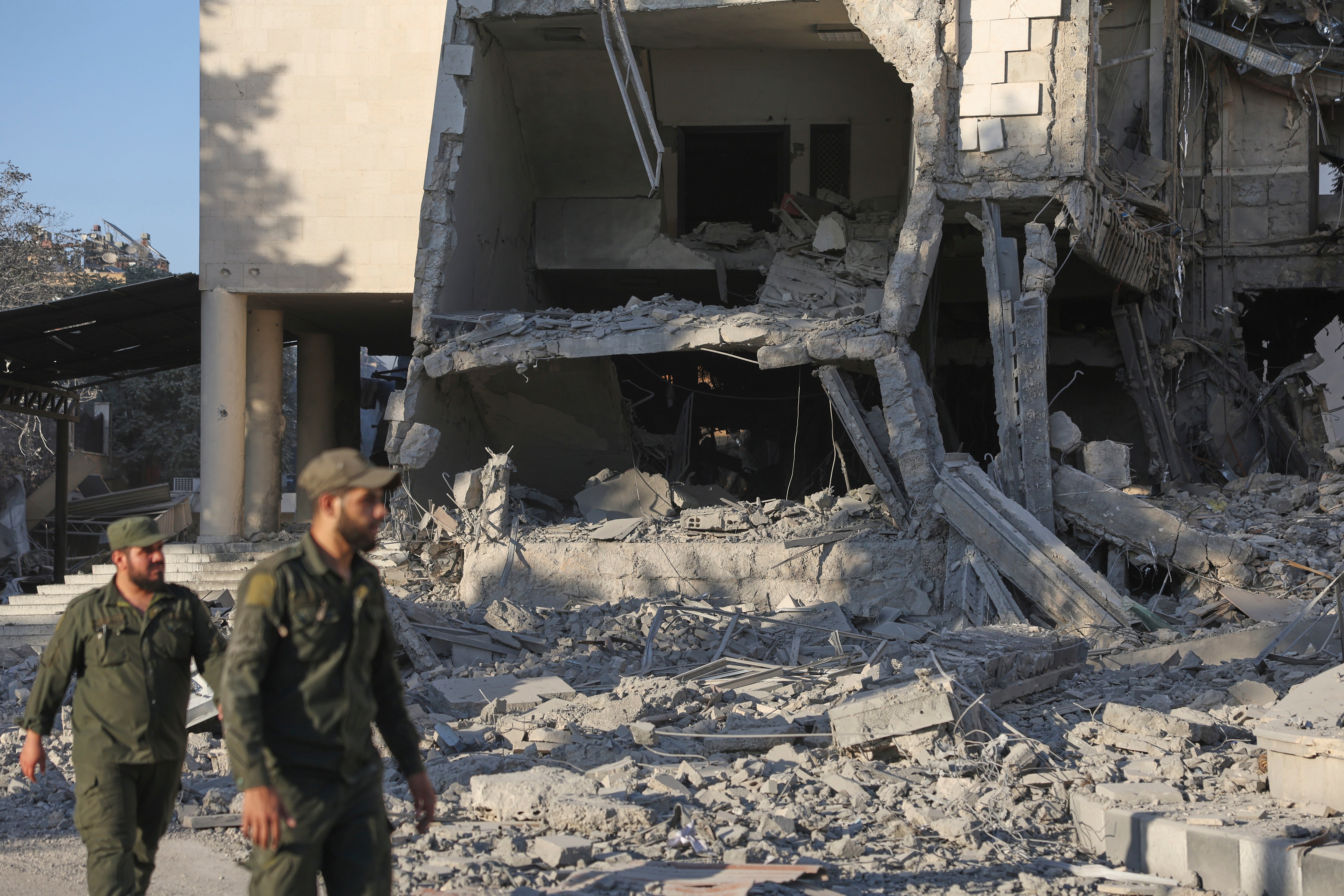 Soldiers inspect the Syrian defense ministry building after it was struck by Israeli warplanes in Damascus on 16 July 2025