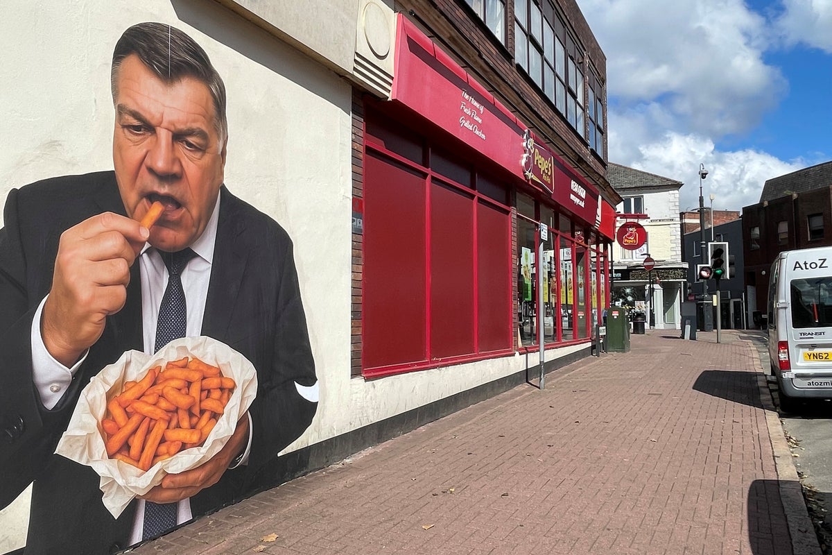 Mystery artwork of former England boss eating chips appears on town centre wall