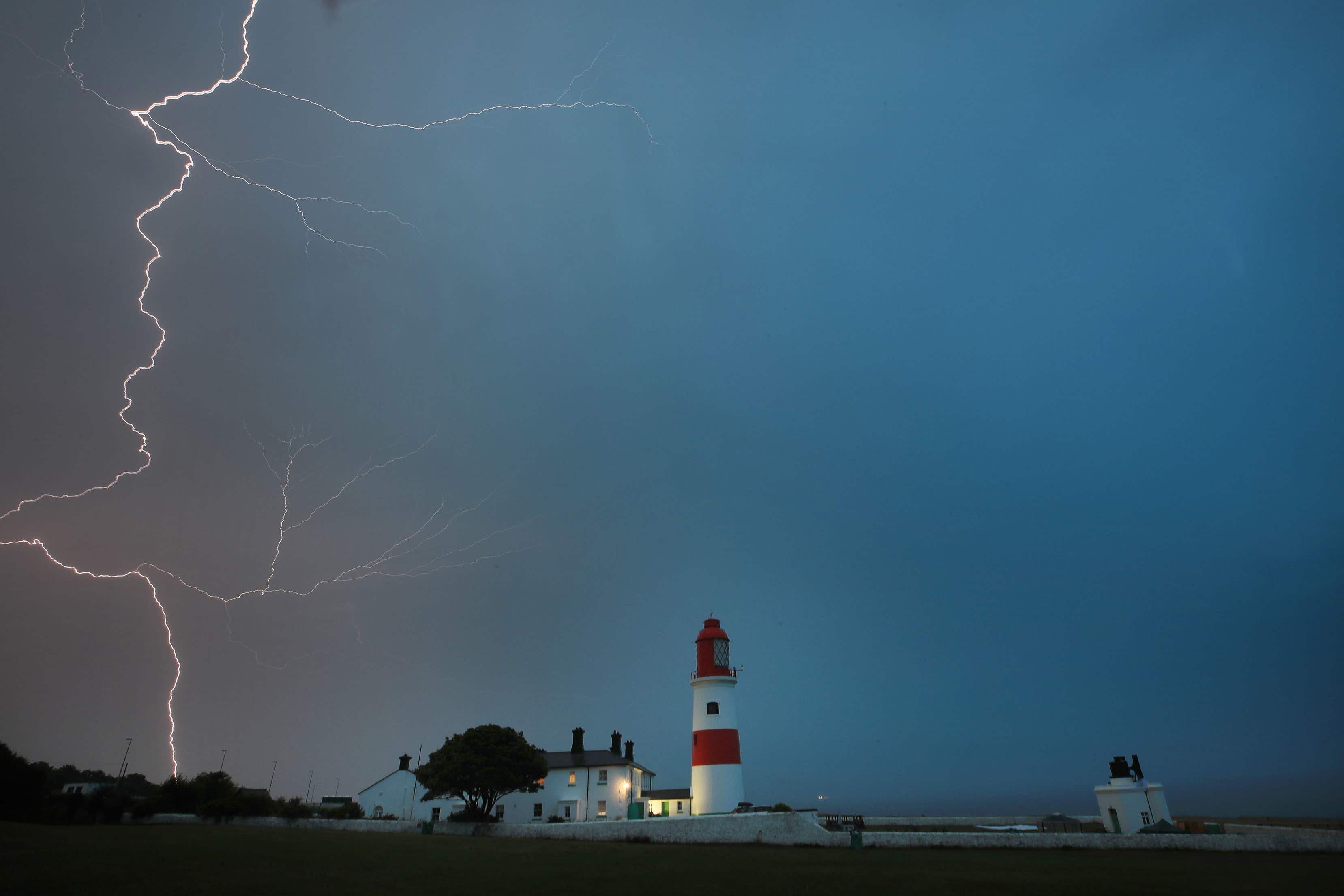 Lightning flashes over Souter lighthouse, South Shields (Owen Humphreys/PA)