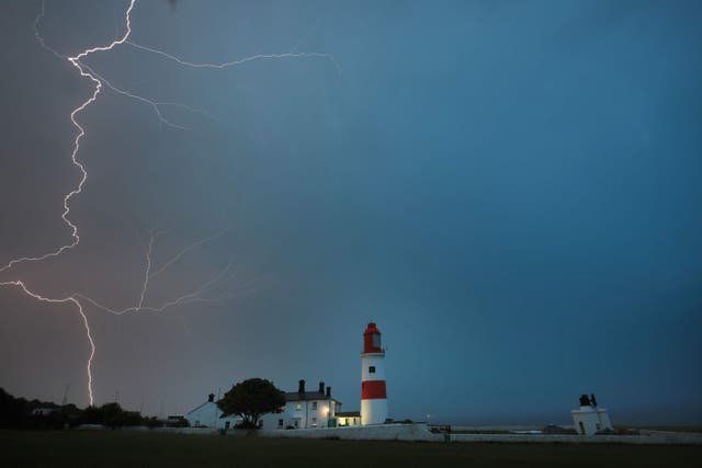 Lightning flashes over Souter lighthouse, South Shields (Owen Humphreys/PA)