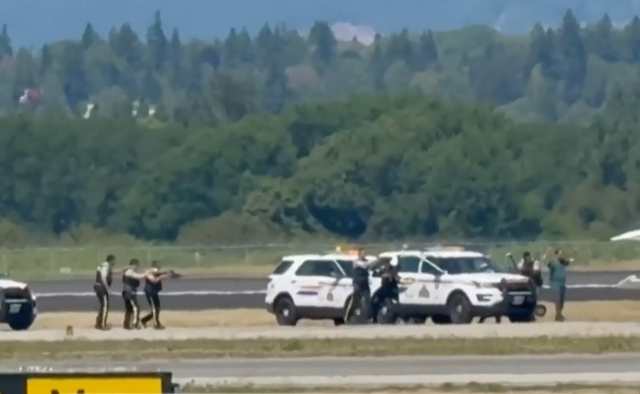 <p>Canadian police prepare to arrest Shaheer Cassim as he walks toward them with his hands up. Cassim has been charged with hijacking, constituting terrorism</p>