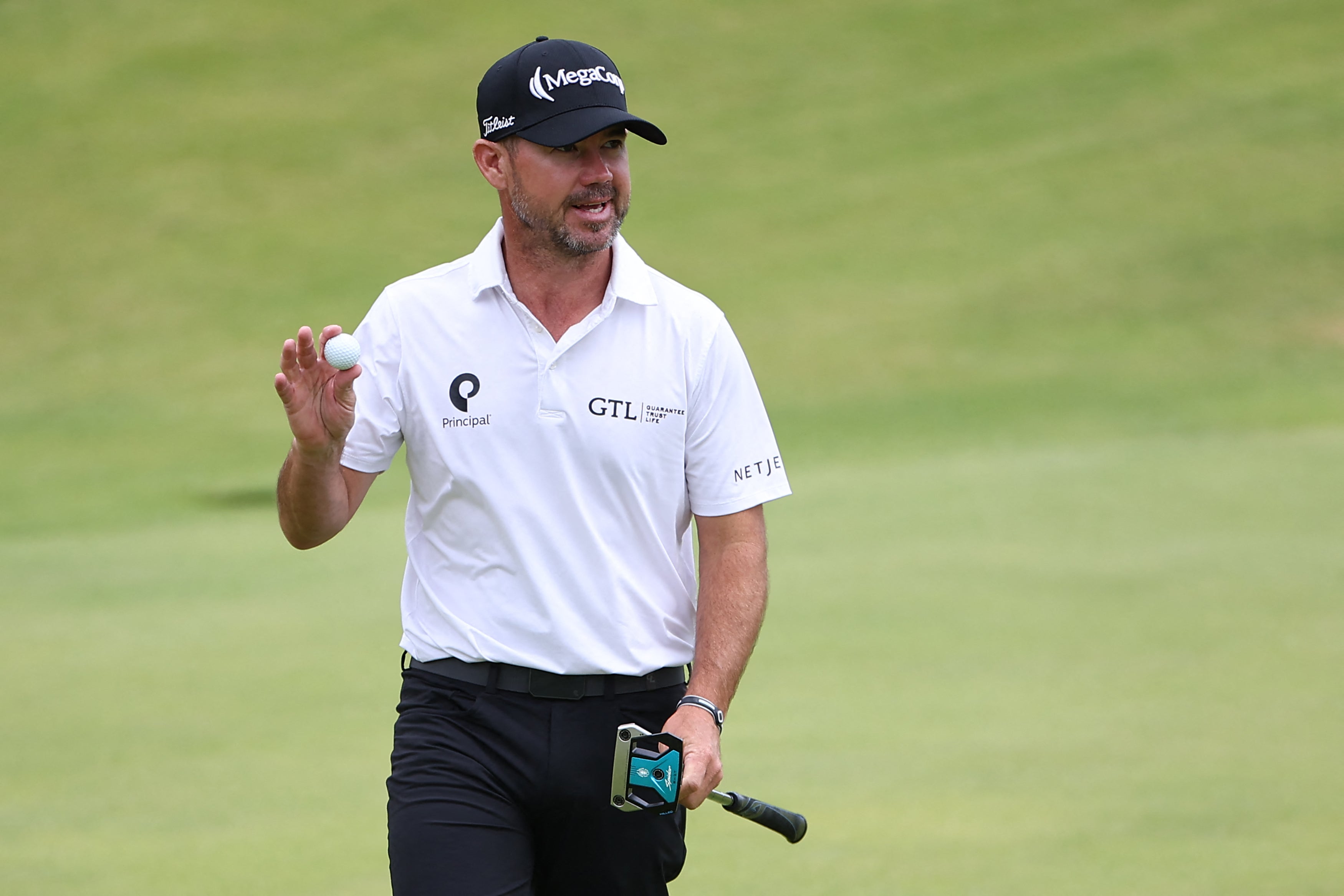 US golfer Brian Harman reacts after making his birdie putt on the 18th green