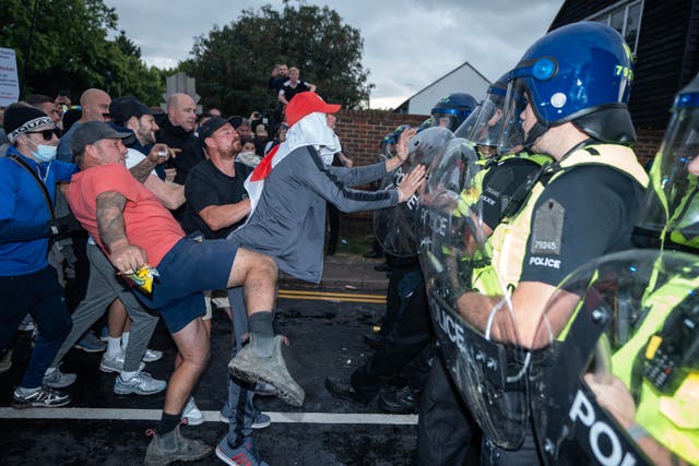 <p>Police and protesters clash outside the Bell Hotel in Essex</p>