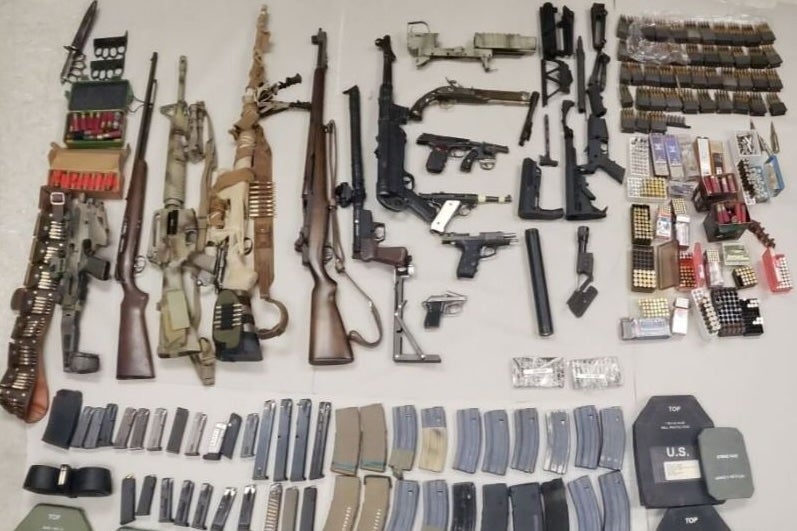 The Riverside County man was in possession of guns, ammo, silencers, and bomb-making materials, police say