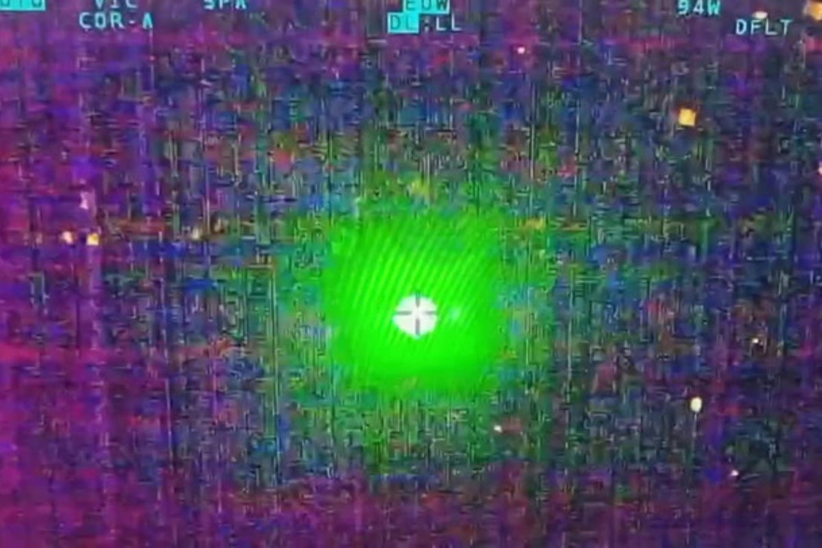 Dangerous moment laser targets police helicopter flying over city